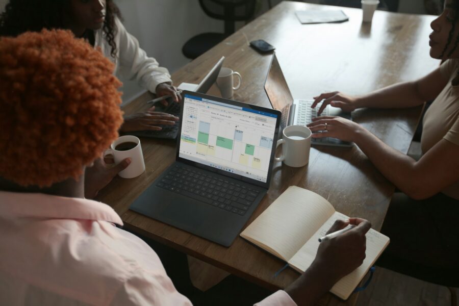 Business team meeting laptop documents diagram