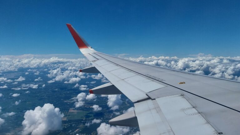 Airplane wing window seat clouds