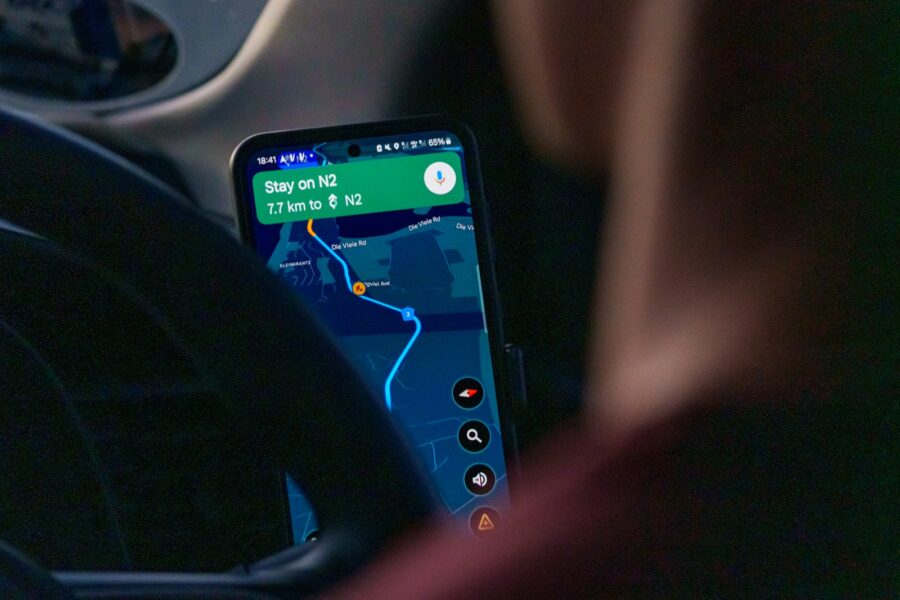 Smartphone navigation app car dashboard night city lights