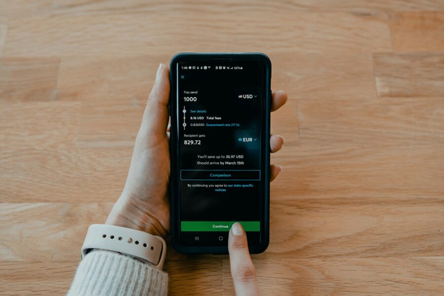 Hand holding phone two factor authentication code screen