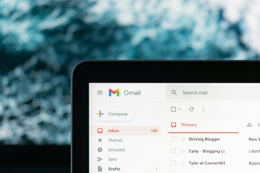 Laptop screen gmail inbox keyboard desk