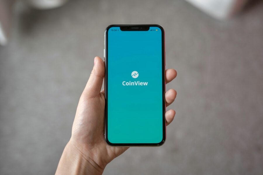 Person holding smartphone app store screen