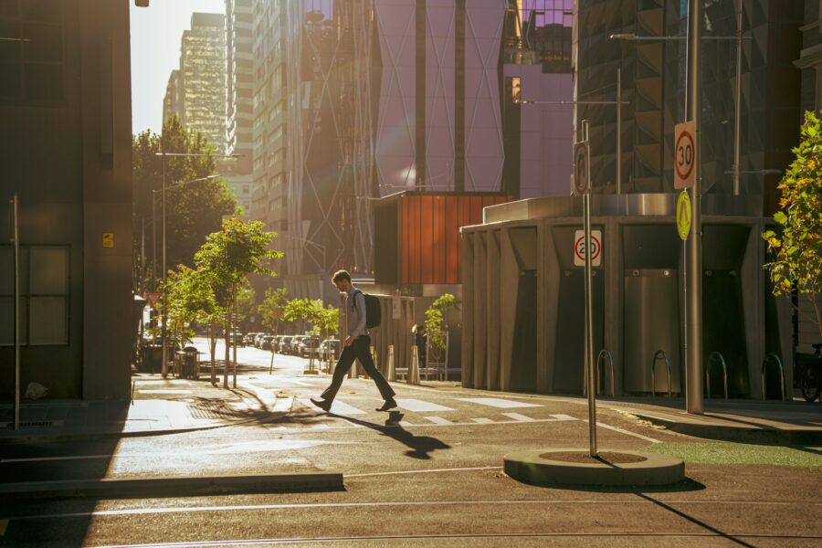 Open world action game character grappling across city