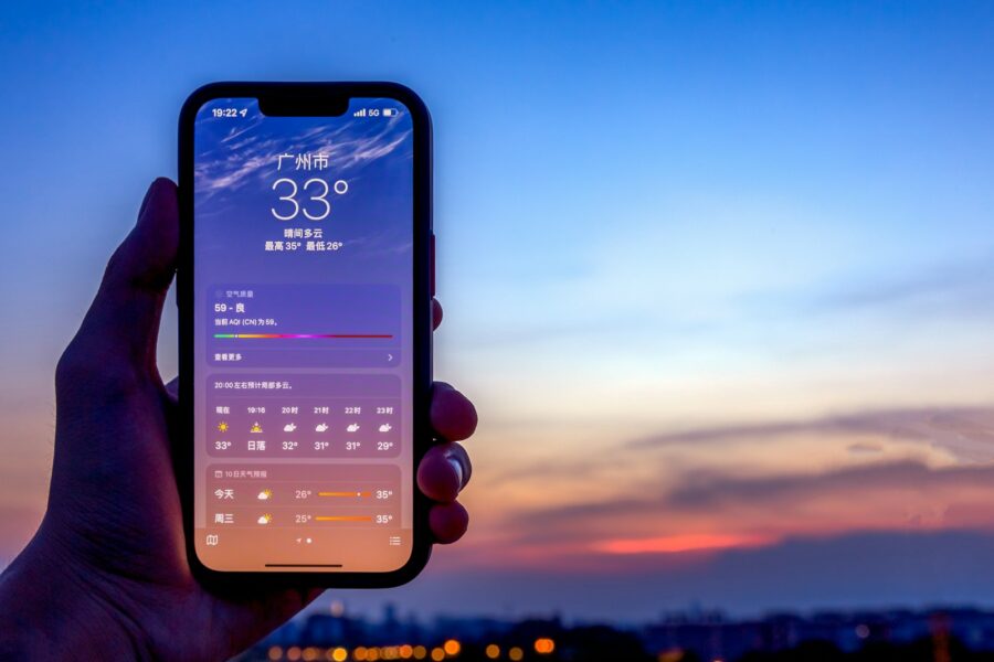 Hand holding phone lock screen widgets closeup