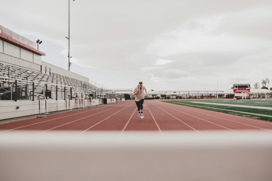 Woman checking fitness app smartphone running track