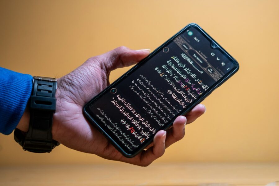 Hand holding phone dual sim settings screen