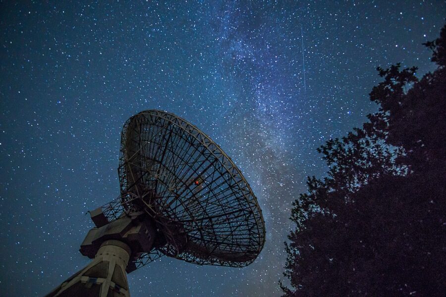 Satellite dish starry night sky smartphone hand