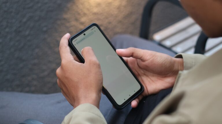 Person phone looking scam alert notification