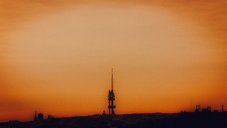 Cell tower antennas city skyline