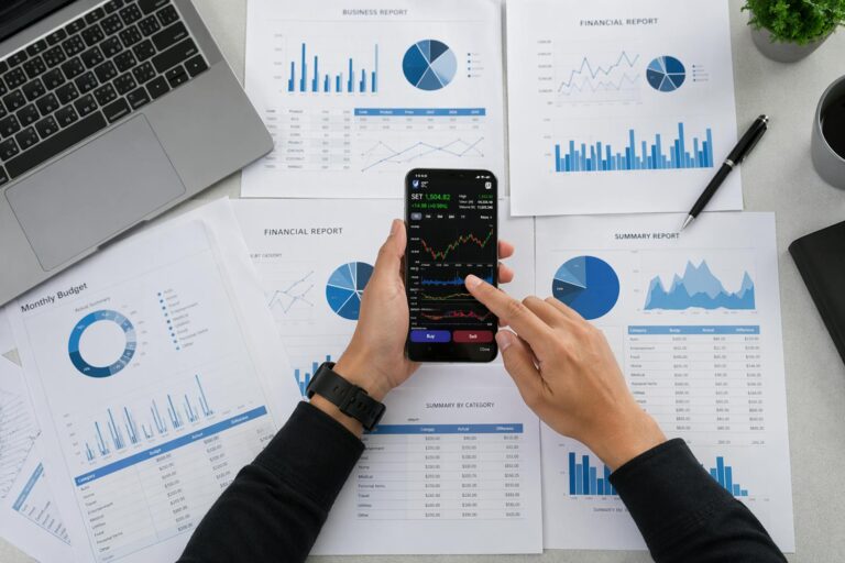 Mobile budget app graphs person reviewing personal finance