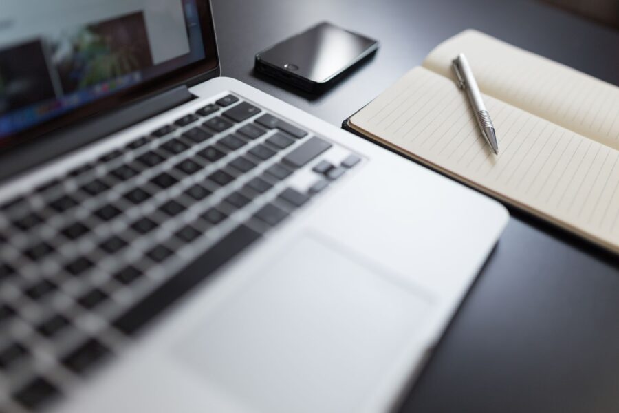 Laptop smartphone note taking app desk