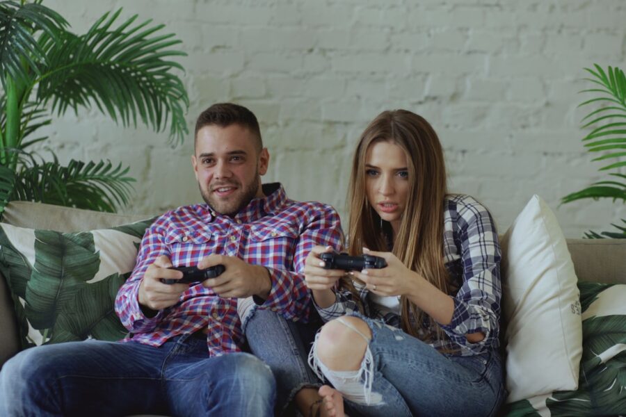 Friends playing co-op puzzle video game living room