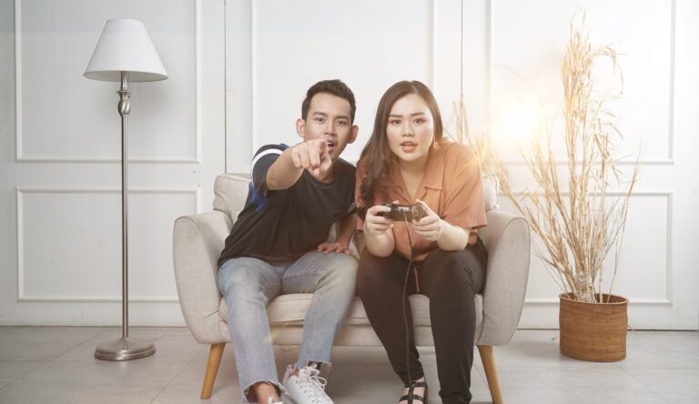 Friends playing co-op puzzle video game living room