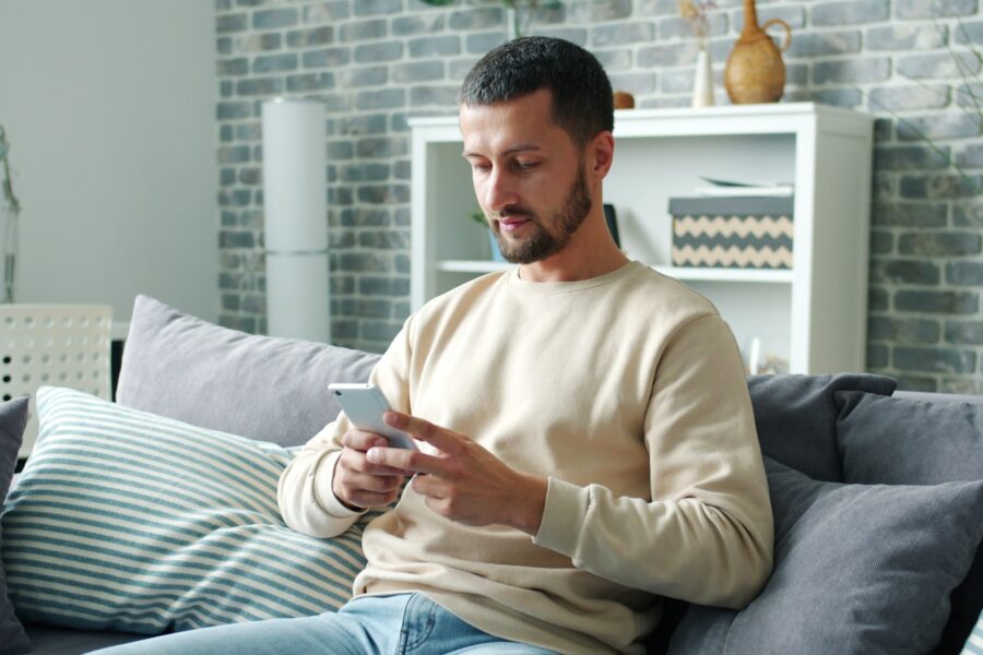 Smartphone meditation app calm person sofa