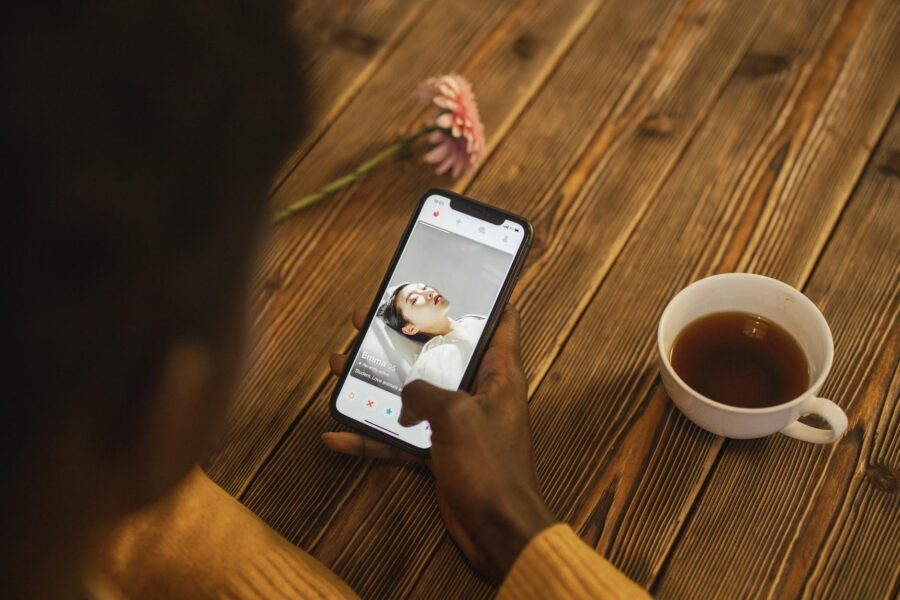 Person using banking app smartphone coffee cup wooden